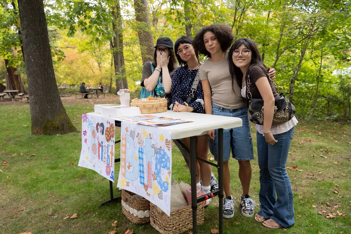 Bright Bites volunteers together at an outdoor cookie fundraising table