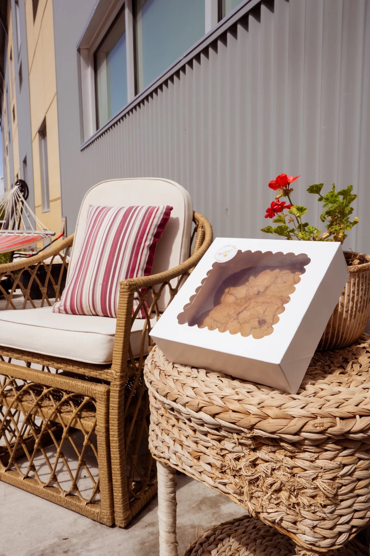 A box of Bright Bites chocolate chip cookies on a wicker table